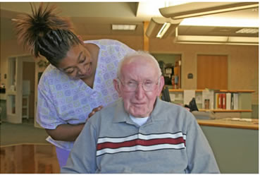 Photograph of staff member with nursing home resident.