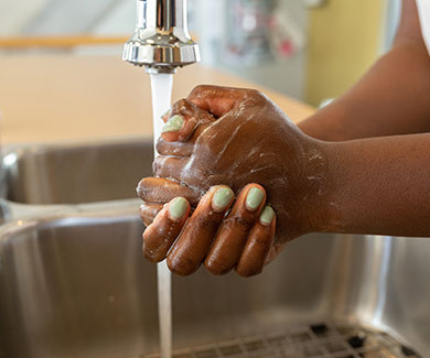 A person washing her hands