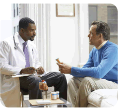 Photo of man talking to his doctor.