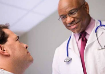 Photo of a doctor and patient talking.